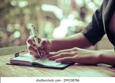 Close Up Of Woman Writing Her Journal