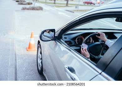 Close up of womand hands on wheel with driving license. Driving school concept. - Shutterstock ID 2108564201