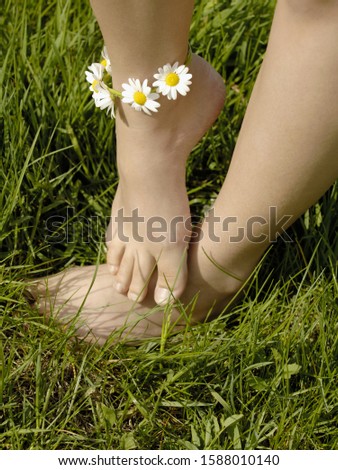 Similar – Image, Stock Photo bare feet on green meadow with white and yellow flowers