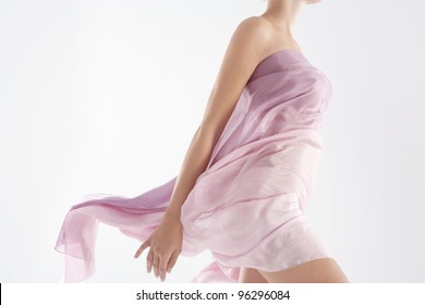 Close up of a woman's body wearing a floaty sarong.