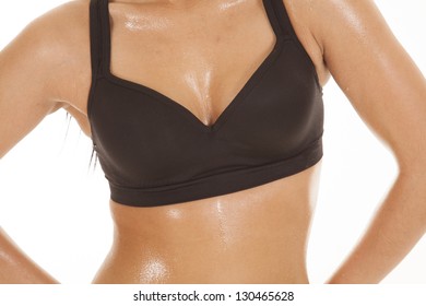 A Close Up Of A Woman's Chest And Stomach With Sweat Dripping Off Of It.