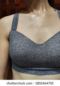 Close Up Of Woman's Chest With Sweat Dripping After Indoor Exercise At Home.