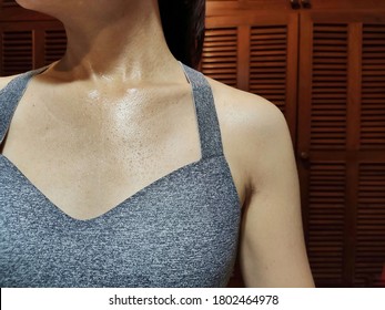 Close Up Of Woman's Chest With Sweat Dripping After Indoor Exercise At Home.