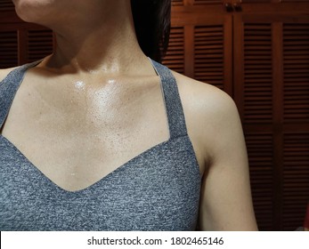 Close Up Of Woman's Chest With Sweat Dripping After Indoor Exercise At Home.