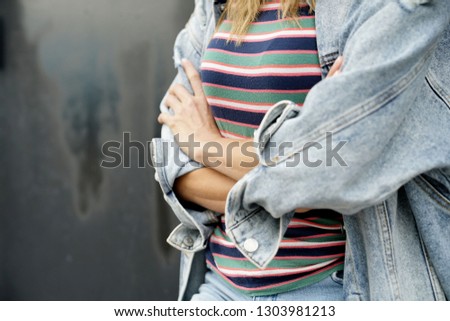 Similar – Frau mit Jeansjacke, blauer Bluse und silberner Armbanduhr.