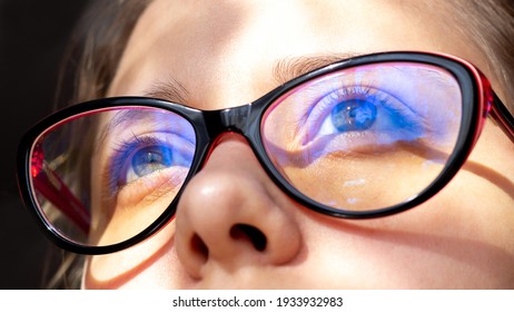 Close Up Of Woman's Eyes With Red And Black Female Glasses For Working At A Computer With A Blue Filter Lenses. Anti Blue Light And Rays. Eye Protection