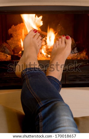 close up of woman's feet in front of an open fire