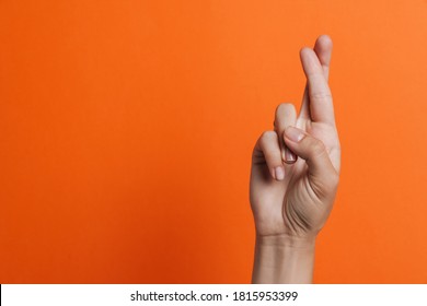 Close Up Of Woman's Fingers Showing Crossed Fingers For Good Luck Isolated