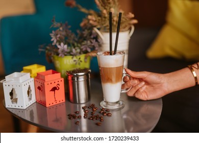 Close Up Of Woman's Hand And Coffee On The Table At Caffee Shop