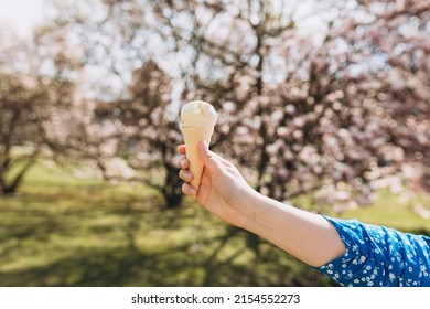 Close Up Womans Hand With Delicious White Ice Cream In Waffle Cone Outdoors. Spring Time, Food Banner