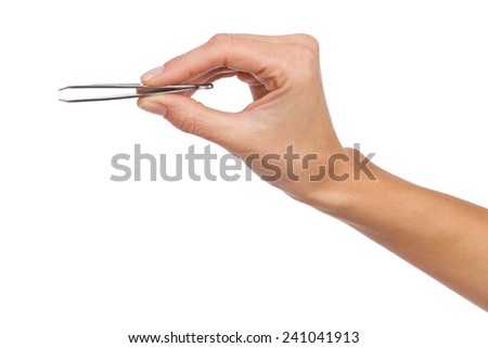 Close up of woman's hand holding an eyebrow tweezers. Studio shot isolated on white.