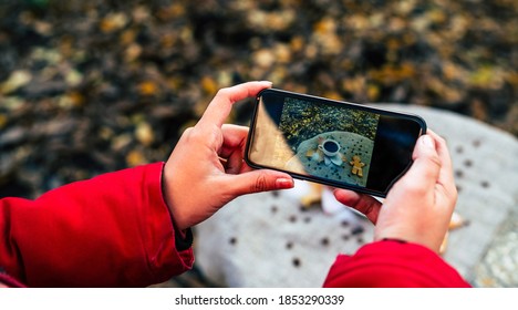 Close Up Of Woman's Hands Photographing On Smartphone Still Life Of Cup Of Coffee With Gingerbread Man. Unrecognizable Female Takes Pictures On Mobile Phone In Autumn Season.