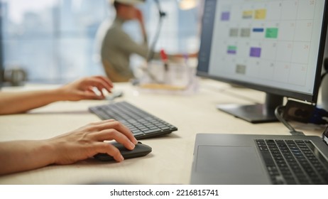 Close Up of a Woman's Hands Working on Keyboard and Monitor. Young Woman's hands Moving the Computer Mouse and Typing. Female Sales Manager Developing a Time Management Plan - Powered by Shutterstock