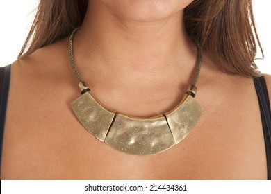 A Close Up Of A Woman's Neck Wearing A Big Bold Necklace.