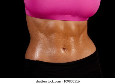 A Close Up Of A Woman's Stomach With Sweat Dripping Off Of It