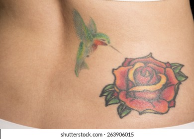 A close up of a woman's tattoo on her back.