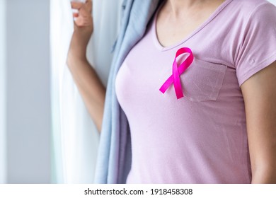 Close up of women disease mammary cancer patient  with pink ribbon wearing headscarf After treatment to chemotherapy at the window In the bedroom at the house,healthcare,medicine - Shutterstock ID 1918458308