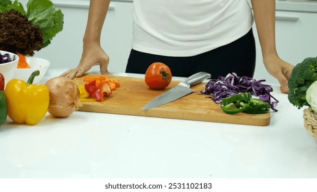 Close up Women hand cutting purple cabbage prepare fruit vegetables green bell pepper carrot tomato at home kitchen. Crop Woman hands use knife cut purple cabbage wooden cutting board vegan healthy - Powered by Shutterstock