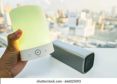 Close Up Women Hand With Glow Yellow Light Bluetooth Speaker With Smart Portable Music Speaker Backdrop