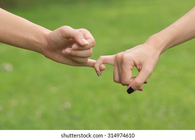 close up women hands making a pinkie for trust ,swear and promise in relationship concept
