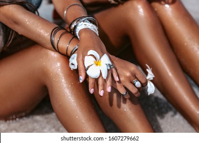close up of women legs with tanned skin on the beach