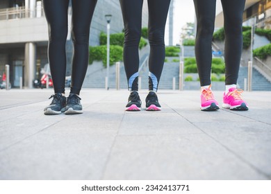 Close up women wearing jogging and running shoes outdoors - Powered by Shutterstock