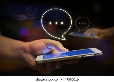Close up of women's hand holding mobile phone at night with bokeh background, chatting,Chat bubble, Chat with friends,social nekwork,  - Shutterstock ID 449580016