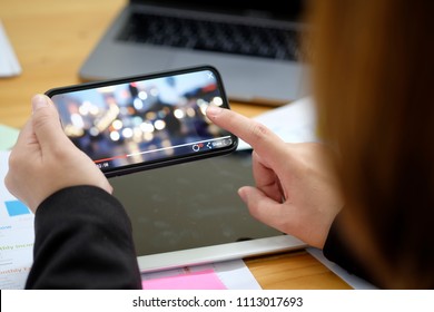 Close Up Of Women's Hands Holding Mobile Phone While Play Video From Network In Office.