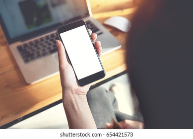 Close up of women's hands holding smart phone with blank copy space white screen for create content. - Shutterstock ID 654421573
