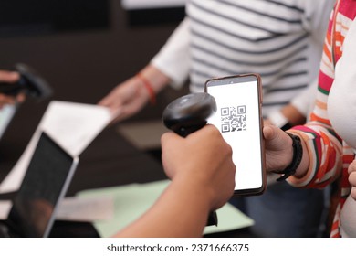 close up of women's hands with QR code reader on mobile phone