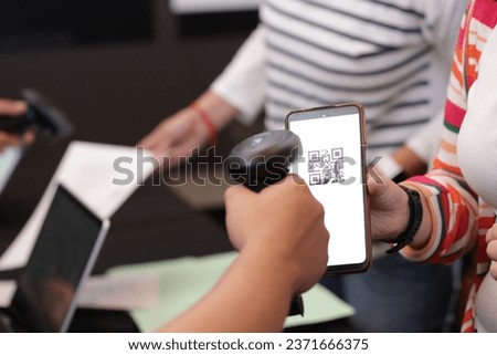 close up of women's hands with QR code reader on mobile phone