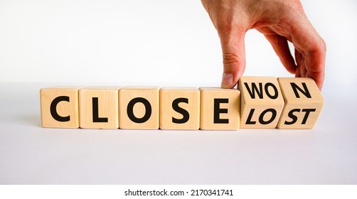 Close won or lost symbol. Businessman turns wooden cubes and changes words Close won to close lost. Beautiful white background, copy space. Business and close won or lost concept.