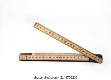 Close up of wood material wooden meter stick folding rule with one segment opened on white background