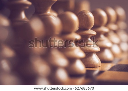 Close up of a wooden chess board and pieces. Selective focus