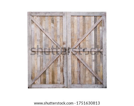 Close up wooden closed door of old barn isolated on white background.