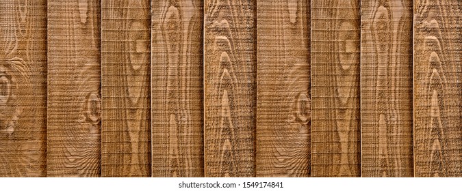 A Close Up Of Wooden Fencing With Vertical, Overlapped Panels.