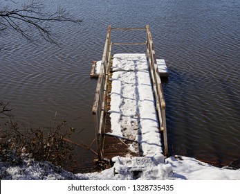 Close Up Of A Wooden Floating Dock Covered With Snow In The Pond