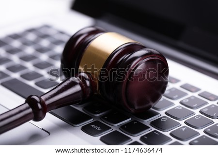 Close Up Of Wooden Gavel On Laptop Keypad