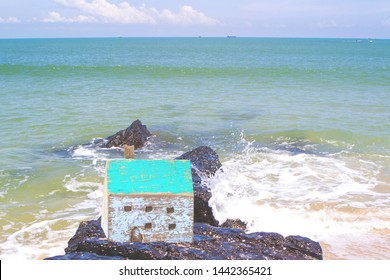 Close up of Wooden house model on the rock with beautiful blue sea with soft wave background, Christian concept from bible, wise man built  house on the rock