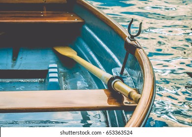 Close up of an wooden pleasure rowboat at the pier of a lake - Powered by Shutterstock