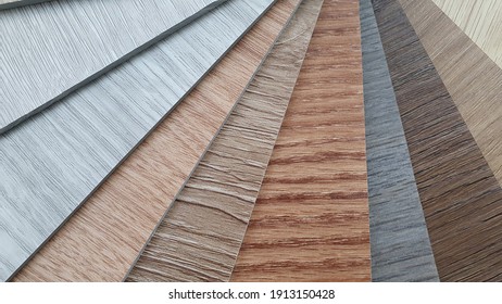 Close Up Wooden PVC Polymer Vinyl Floor Tile Samples For Customers To Choose. Various Patterns And Colors Of Wooden Vinyl Floor Tile Sample Swatch.