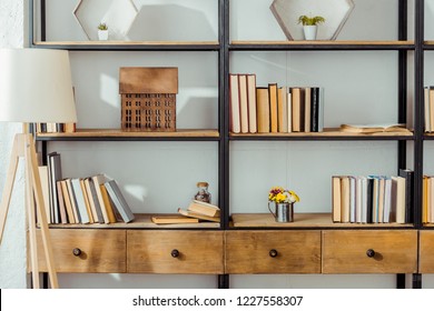 close up of wooden rack with books in living room  - Shutterstock ID 1227558307