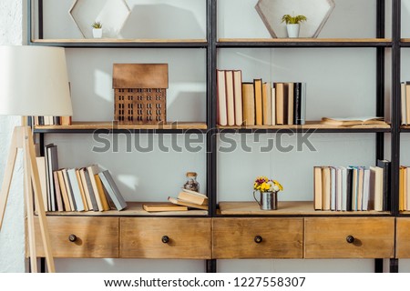 close up of wooden rack with books in living room 