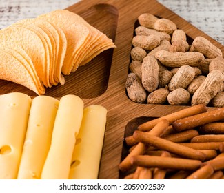 Close Up Of Wooden Tray With Meat And Cheese, Antipasto Snacks. Antipasto Cold Meat Dish With Breadsticks, Prosciutto, Ham, Ham Slices And Cheese On A Wooden Tray