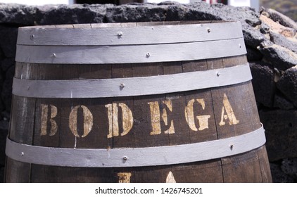 Close Up Of Wooden Wine Barrel With Text Bodega In Front Of Natural Stone Wall - Lanzarote