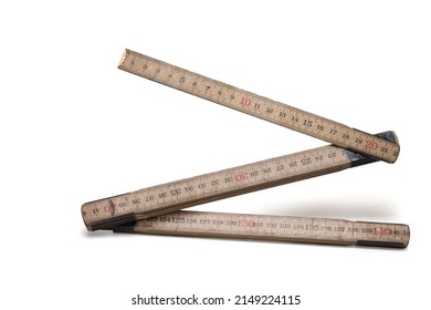 Close up of wooden wood material folding ruler meter stick with two segments opened and visible digits on white background
