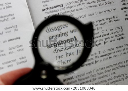 Close up of a word argument through the loupe, definition of word 