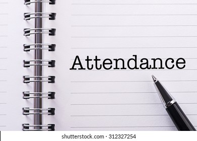 Close Up Word Attendance On Notebook