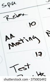 Close Up Of The Words AA Meeting Hand Written On A Calendar As A Concept