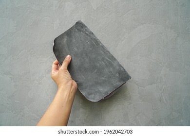 Close Up Worker Hand Use Sandpaper Sheet For Smooth Cement Wall Texture